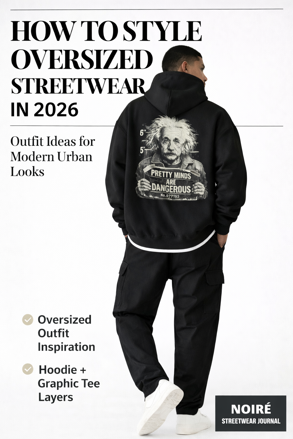 model wearing oversized black streetwear hoodie with graphic back print modern urban outfit inspiration noiré streetwear styling