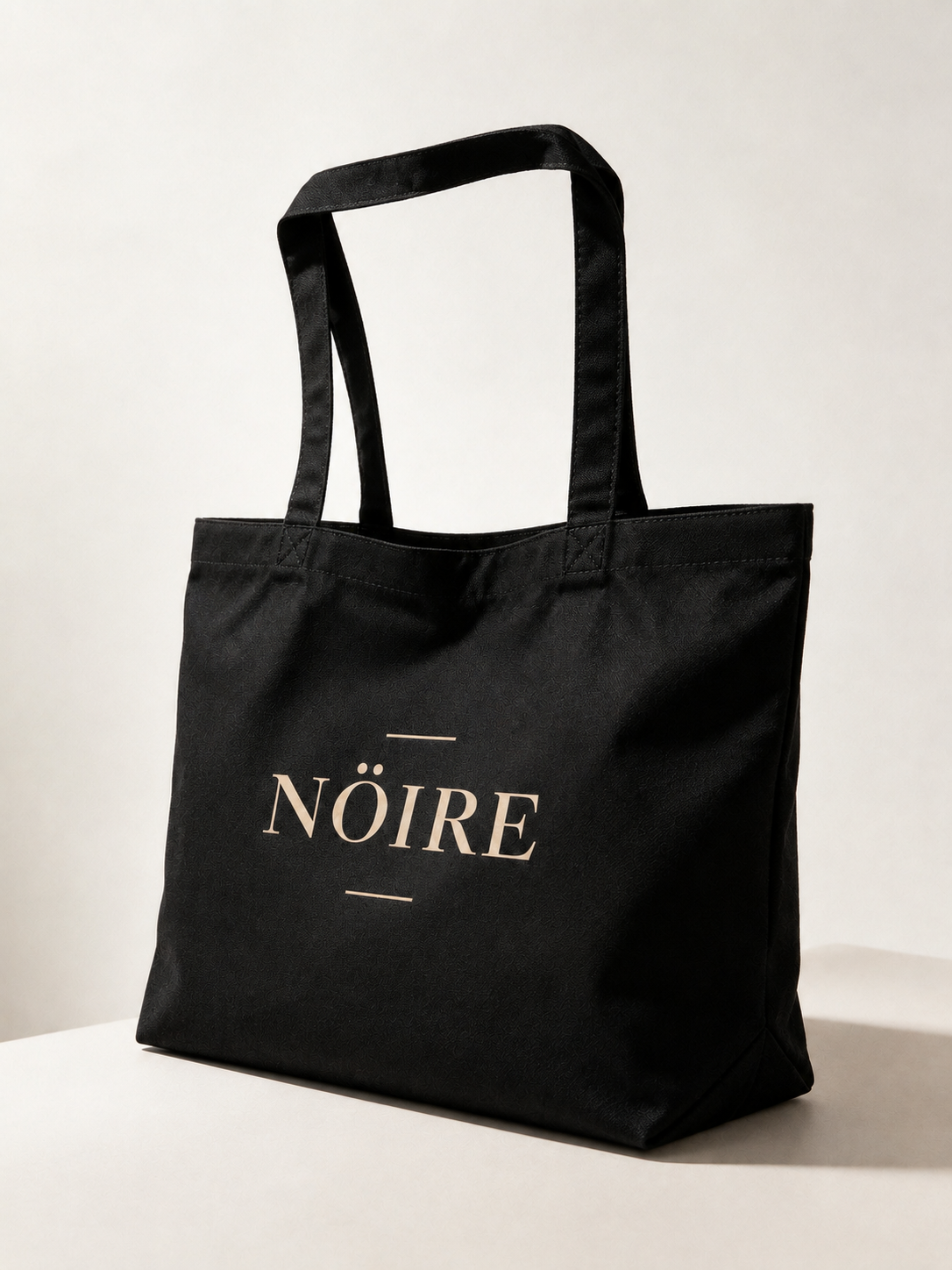 Black Nöiré logo tote bag, angled product view
