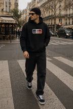 model walking crossing street wearing oversized black hoodie paris urban streetwear outfit
