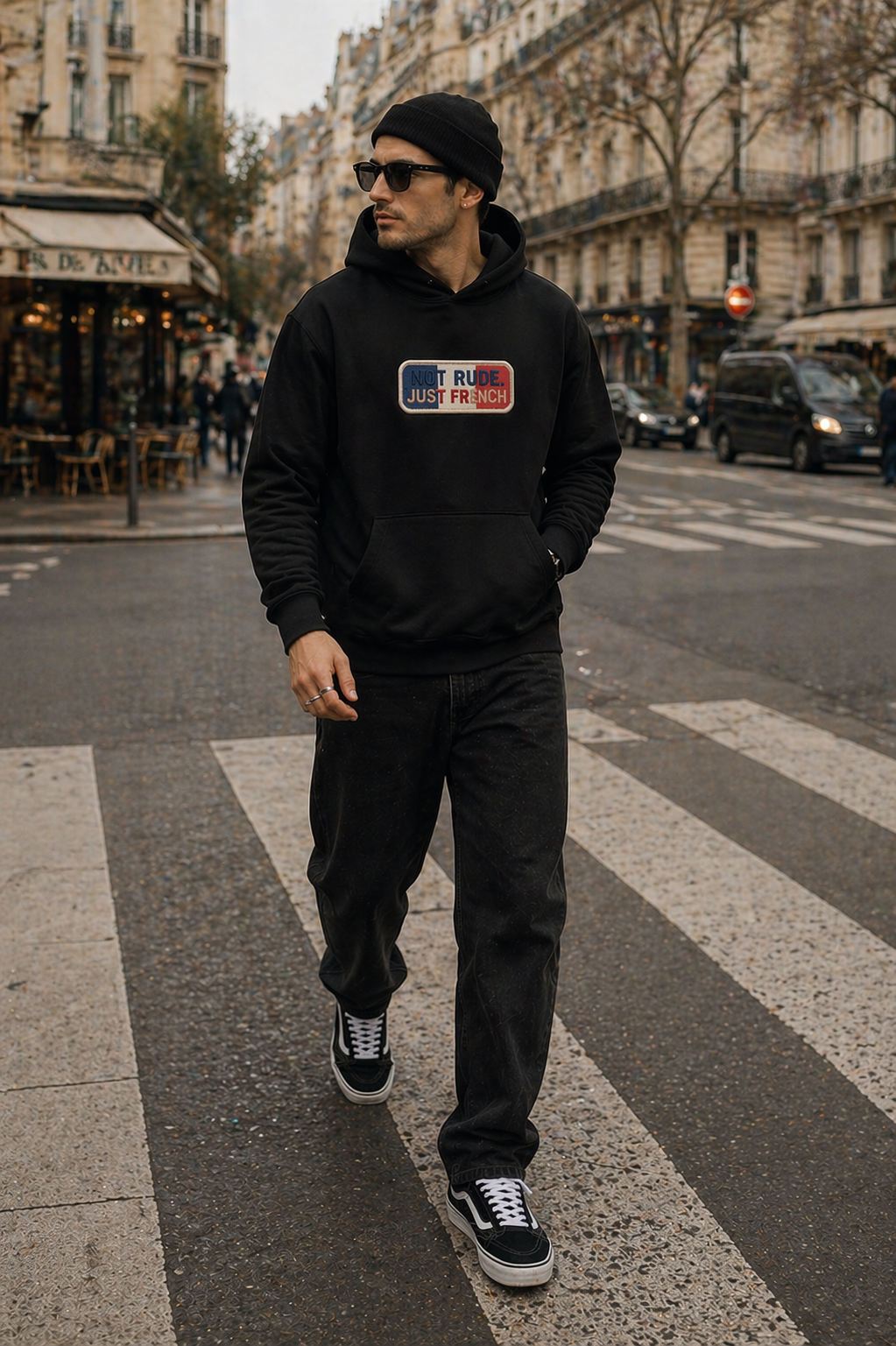 model walking crossing street wearing oversized black hoodie paris urban streetwear outfit
