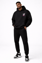 male model full body pose wearing oversized black graphic streetwear hoodie streetwear fashion outfit