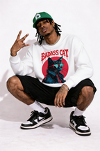 male model sitting pose wearing oversized white graphic streetwear sweatshirt badass cat illustration streetwear fashion