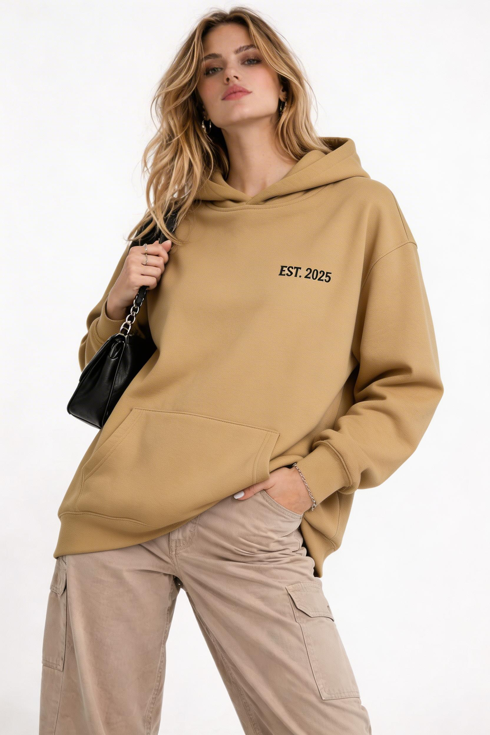 female model front pose wearing oversized brown minimal streetwear hoodie noiré est 2025 logo clean aesthetic outfit
