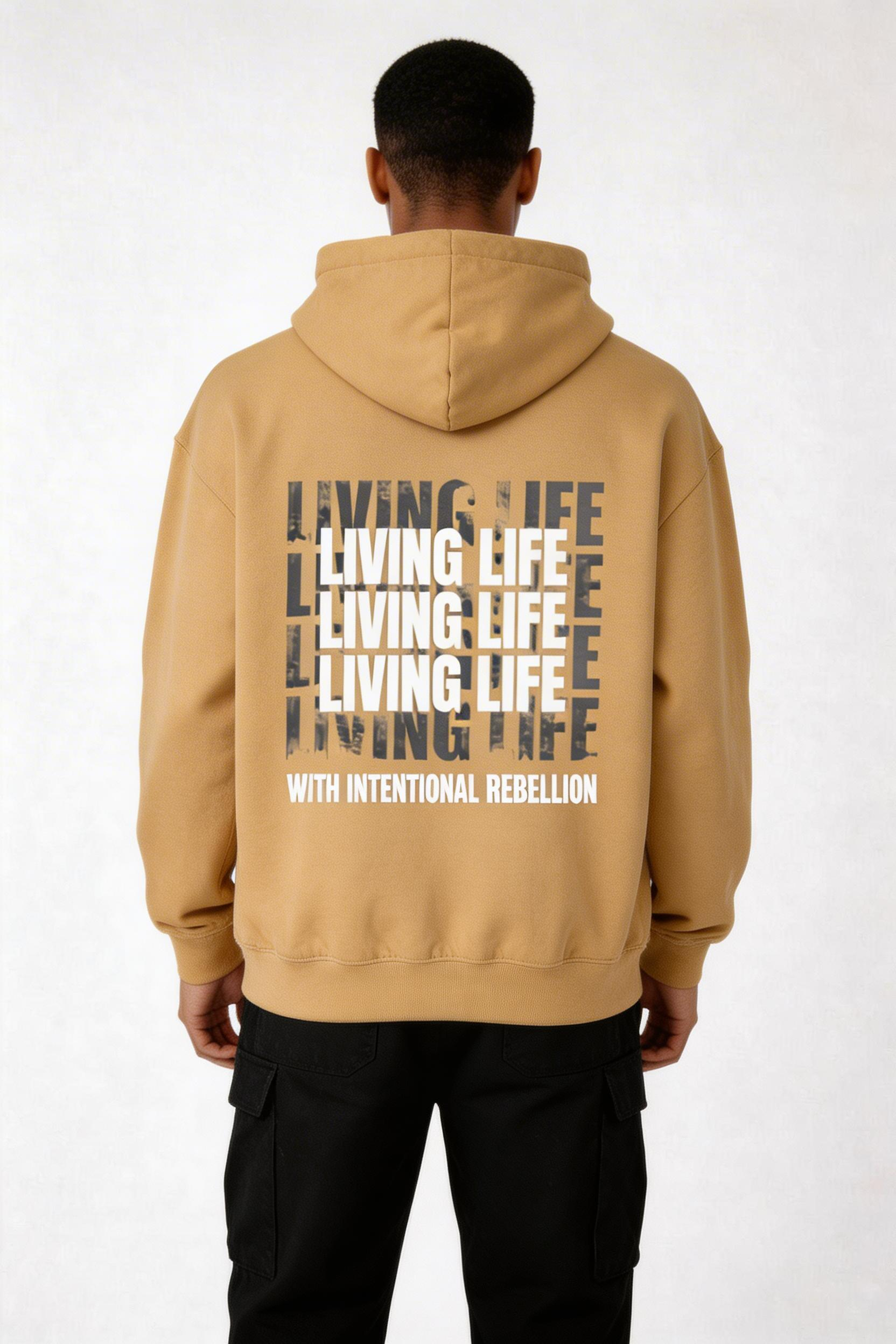 male model back view wearing oversized brown graphic hoodie living life typography design with intentional rebellion streetwear outfit