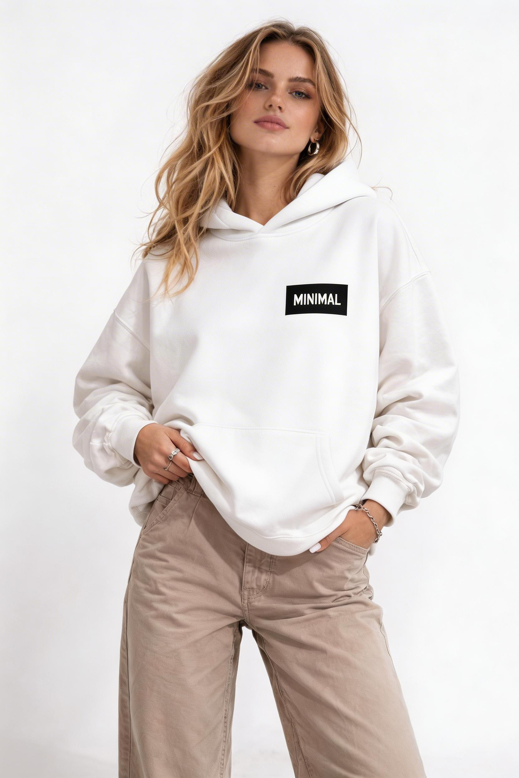 female model front pose wearing oversized white hoodie minimal logo chest design urban streetwear outfit