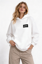 female model front angle pose wearing oversized white hoodie minimal branding design streetwear clothing