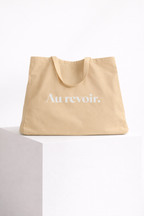 product front view beige tote bag au revoir typography design streetwear fashion