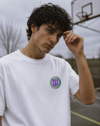 male model close up wearing white oversized graphic t shirt 90s era chest print urban streetwear outfit