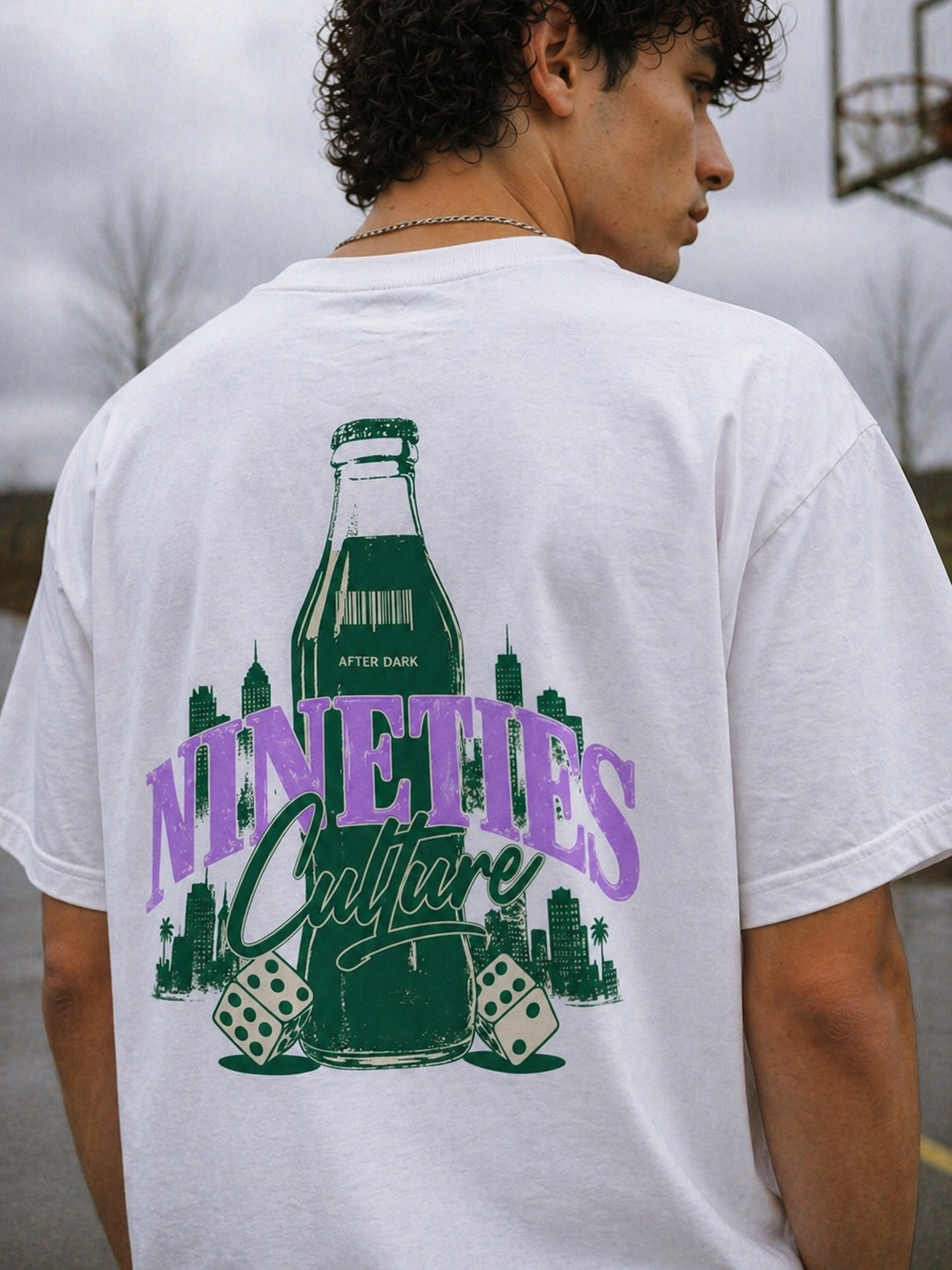 male model close up back view wearing white oversized graphic t shirt nineties culture retro bottle artwork streetwear fashion