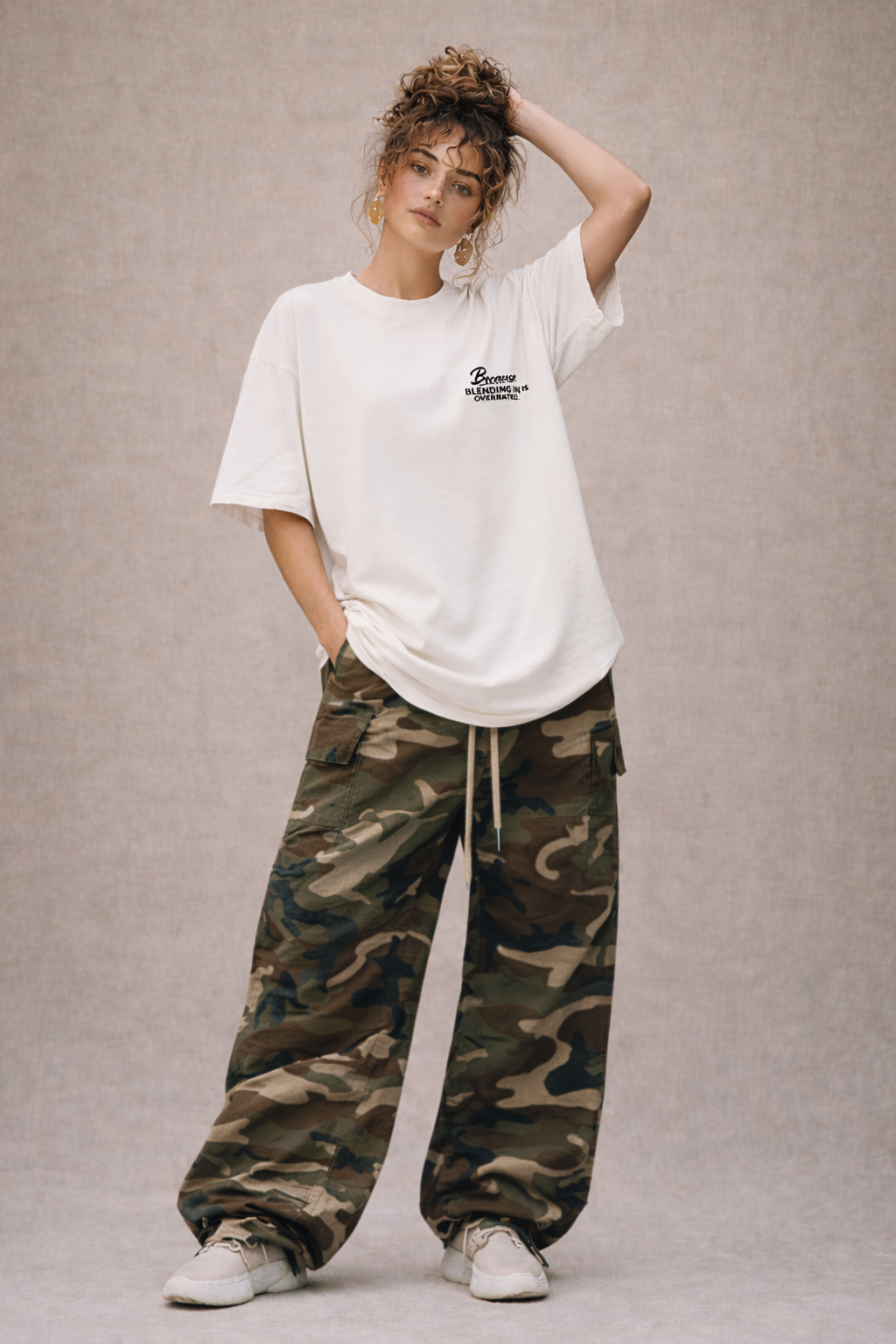 female model wearing oversized beige graphic t-shirt because blending in is overrated streetwear outfit