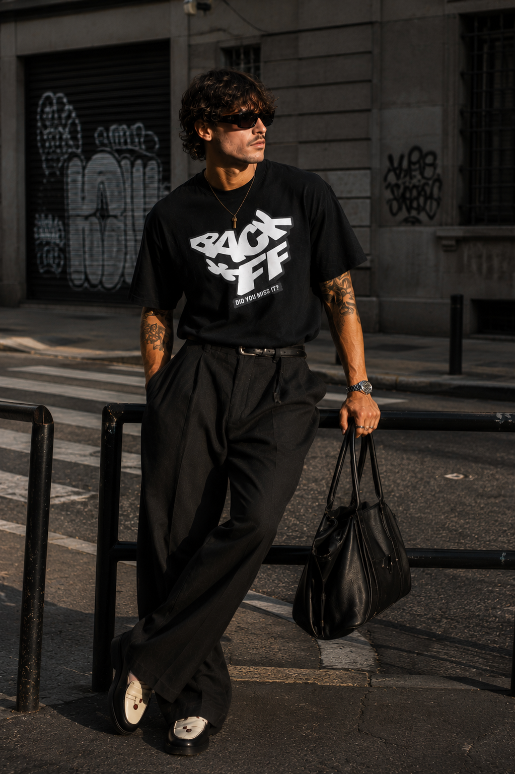 model leaning rail pose wearing oversized black graphic t shirt back off design graphic streetwear