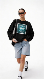 female model close up wearing oversized black sweatshirt soft face sharp mind graphic print modern streetwear outfit