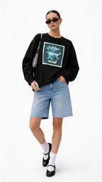 female model full body wearing oversized black sweatshirt soft face sharp mind graphic streetwear fashion outfit with denim shorts