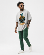 model side walking view wearing oversized heather grey graphic t shirt with street royalty animal artwork urban streetwear fashion