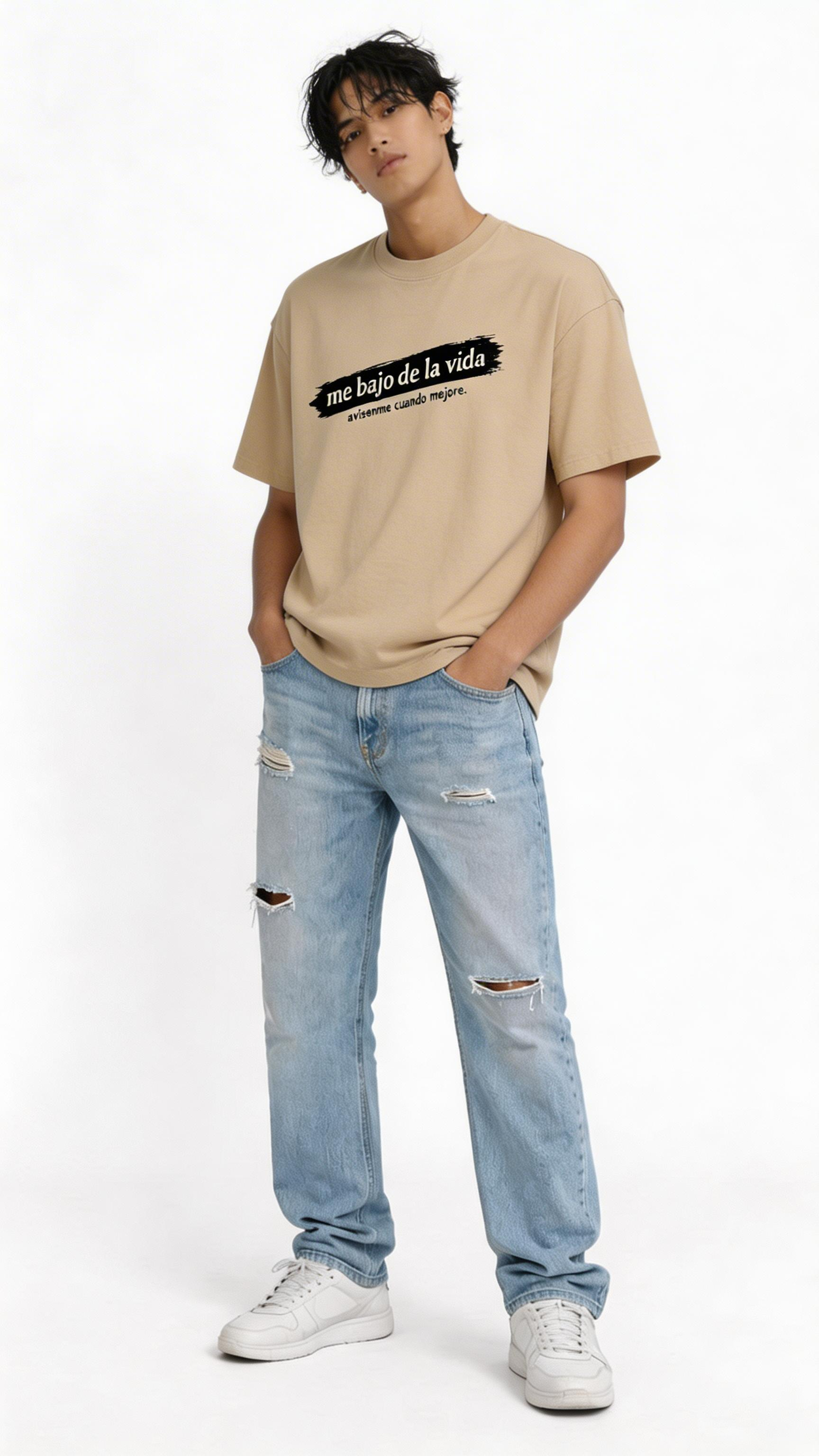 male model wearing oversized beige graphic streetwear t-shirt me bajo de la vida design casual urban streetwear outfit full body