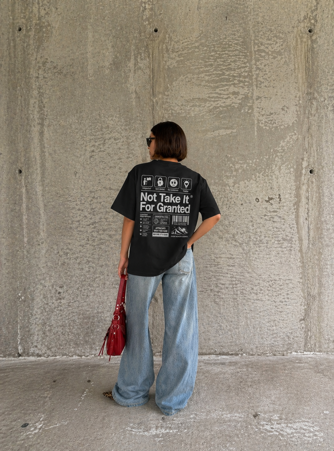 Back view model wearing oversized black graphic t-shirt streetwear fashion