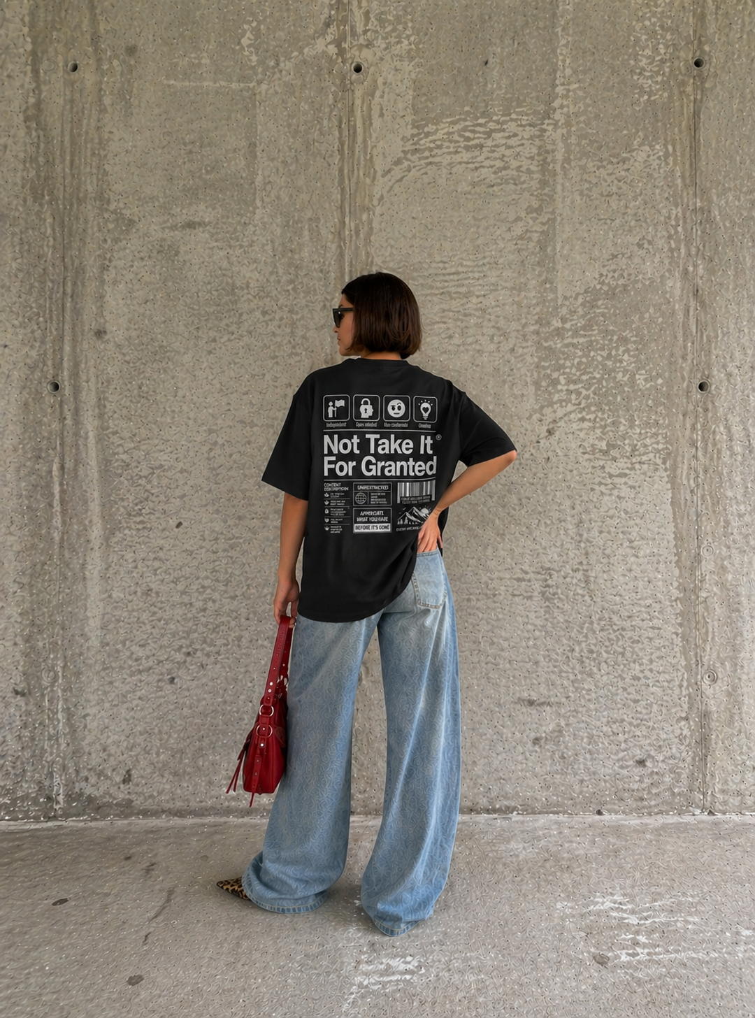 back view model standing wearing oversized black graphic t-shirt not take it for granted urban streetwear outfit