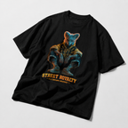 angled flat lay black oversized streetwear tee with futuristic animal graphic and bold orange streetwear typography