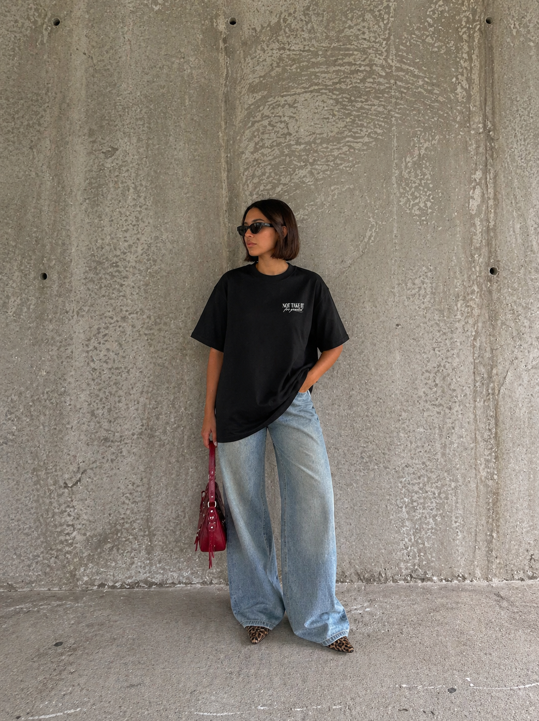 front view model standing wearing oversized black graphic t-shirt casual streetwear fashion