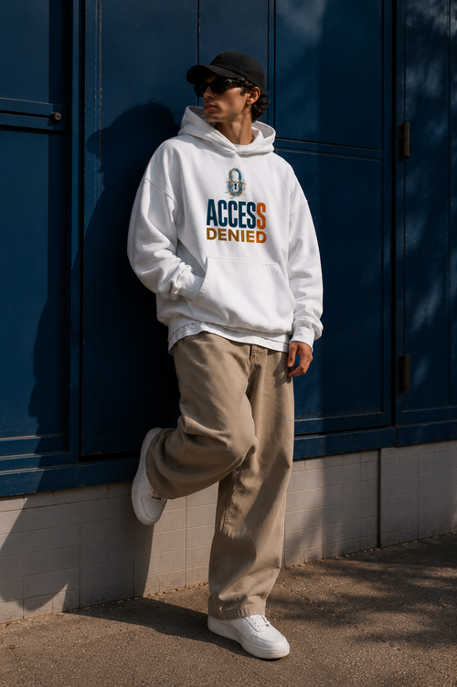 male model leaning against blue wall wearing oversized white hoodie with typography graphic urban streetwear look
