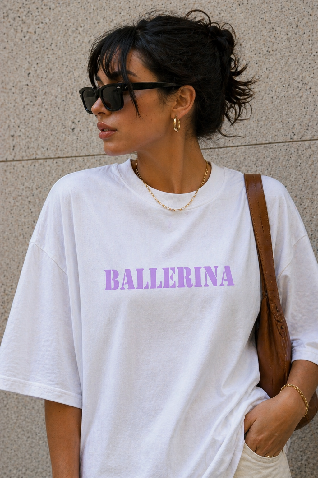 close up model wearing oversized white ballerina graphic t-shirt with pastel purple front logo sunglasses urban streetwear outfit