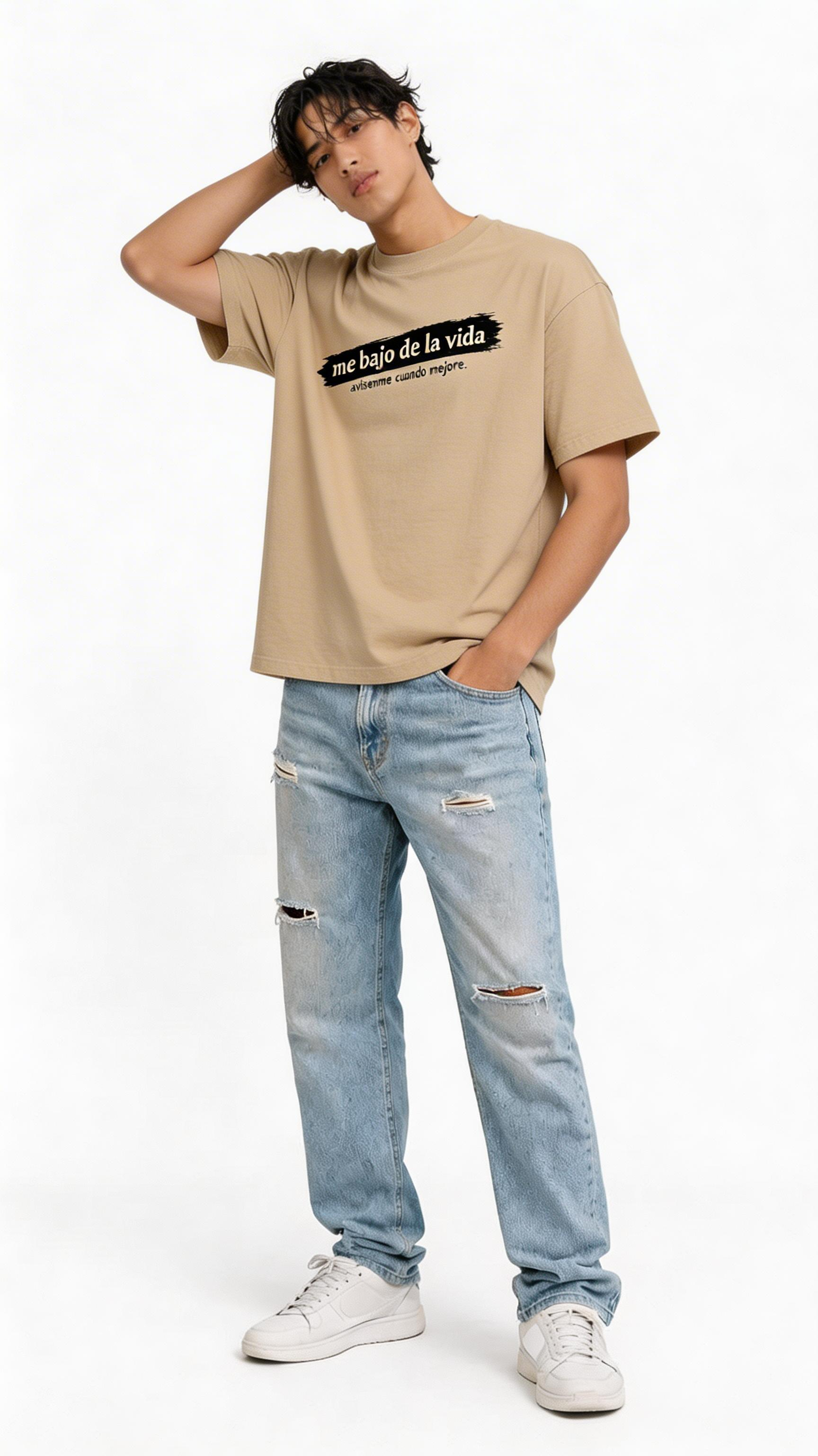 male model wearing oversized beige statement graphic t-shirt me bajo de la vida streetwear outfit relaxed fit urban fashion