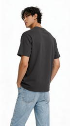 Back view oversized black streetwear t shirt worn by male model showing clean back with neon statue graphic front design
