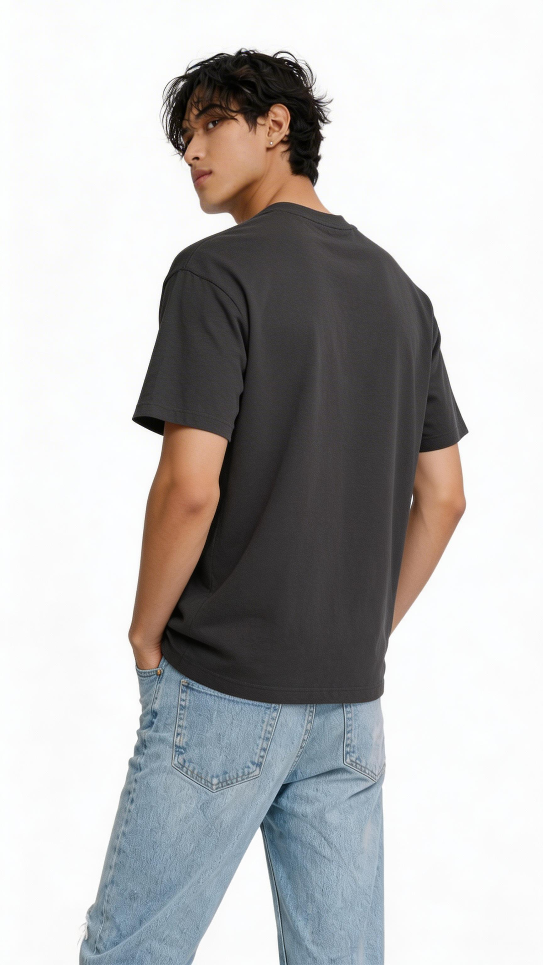 Back view oversized black streetwear t shirt worn by male model showing clean back with neon statue graphic front design