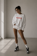 model standing wearing oversized white ballerina graphic sweatshirt red statement design streetwear fashion