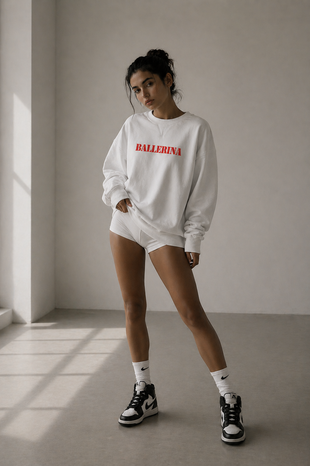 model standing wearing oversized white ballerina graphic sweatshirt red statement design streetwear fashion