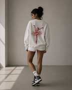 model back view wearing oversized white graphic sweatshirt with red ballerina sketch print urban streetwear outfit
