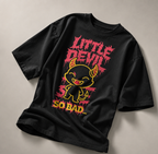 oversized black graphic t shirt featuring little devil cartoon artwork with red typography and bold urban streetwear style