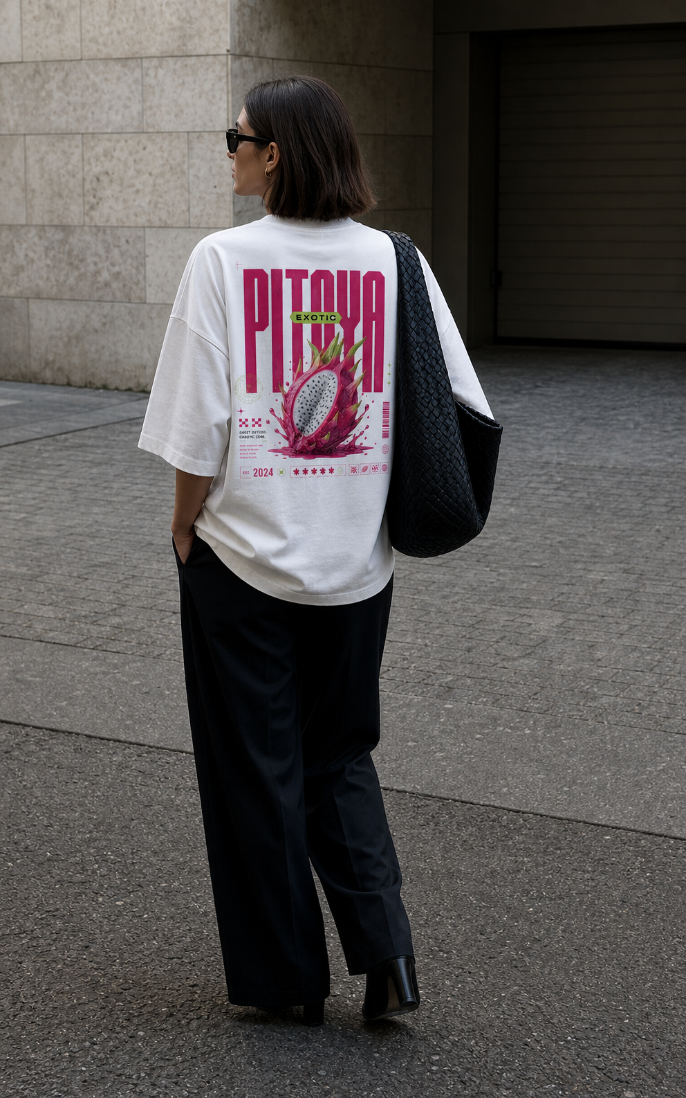 model walking back view wearing oversized white graphic t shirt pink pitaya graphic urban streetwear outfit
