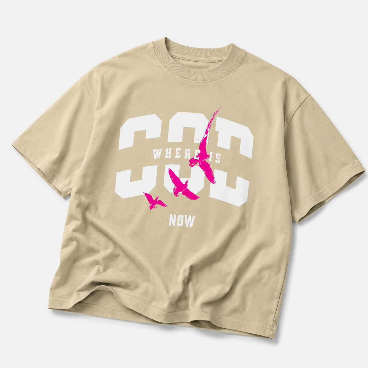 beige oversized graphic t shirt with pink bird statement artwork laid flat urban streetwear fashion