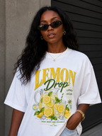 model close up portrait wearing oversized white lemon drop lemonade graphic t shirt summer edition print relaxed fit urban streetwear outfit