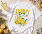 product lifestyle flat lay white oversized lemon drop lemonade graphic t shirt with citrus summer aesthetic urban streetwear outfit