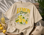 product lifestyle flat lay beige oversized lemon drop lemonade graphic t shirt with summer aesthetic urban streetwear outfit