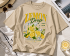 styled flat lay beige relaxed fit lemon drop graphic t shirt with citrus lemonade print summer streetwear fashion
