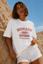 model leaning pose wearing oversized white graphic t shirt monaco heritage design streetwear fashion