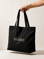 Black Nöiré logo tote bag, hanging lifestyle product view