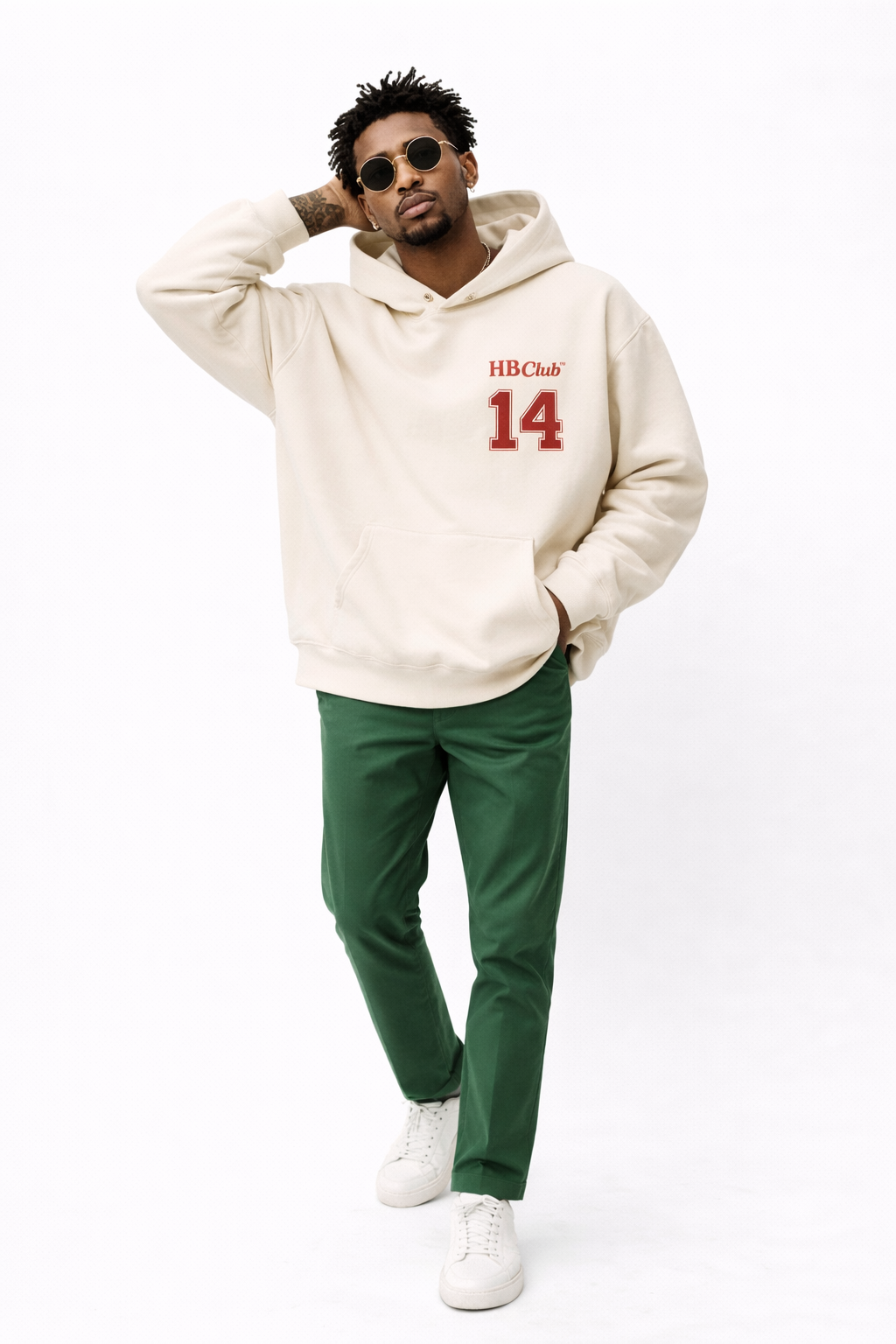Male model in beige oversized hoodie featuring red “14” front print, contemporary streetwear fashion