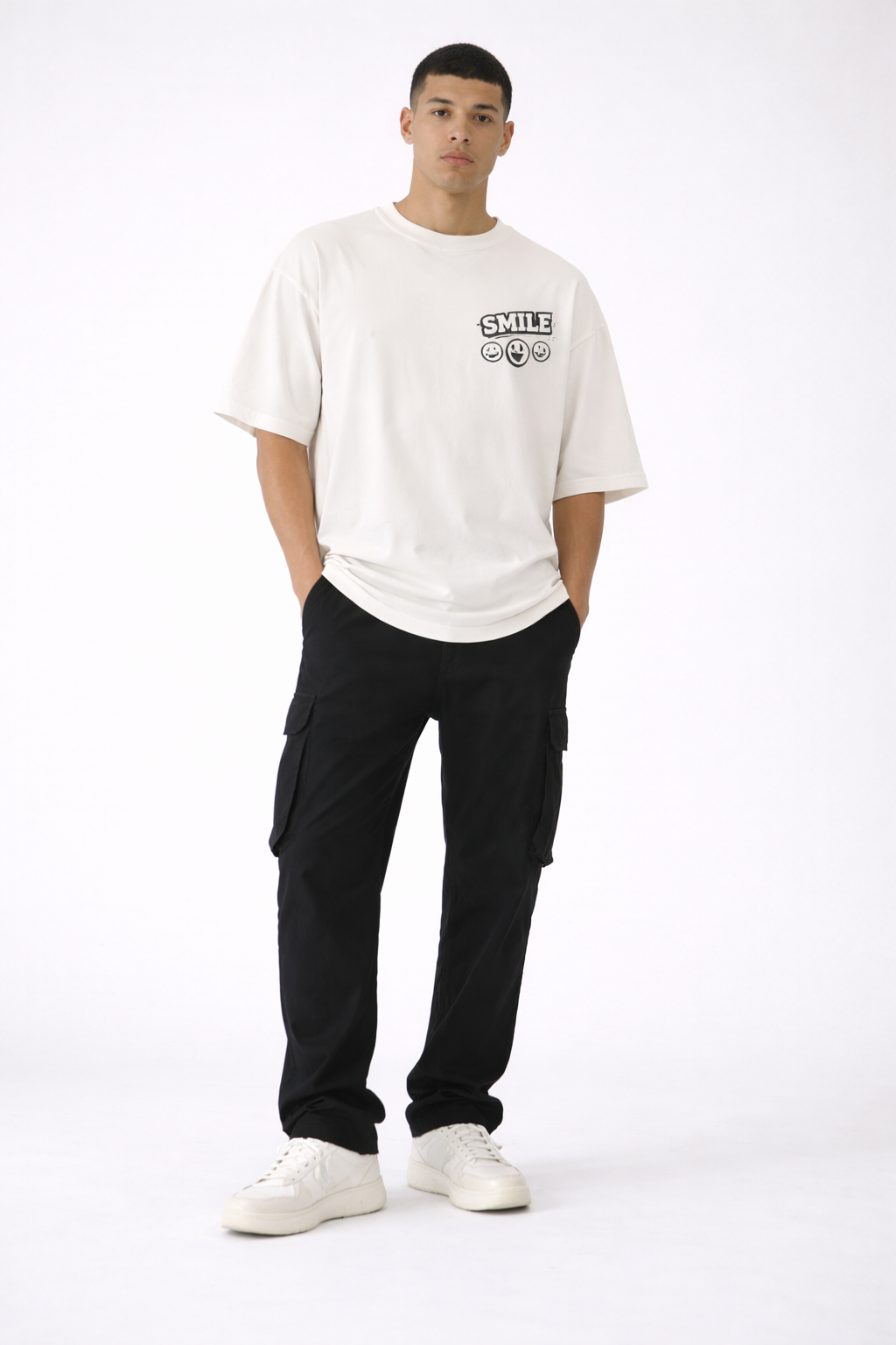 male model wearing oversized beige smile graphic streetwear t-shirt urban streetwear outfit full body