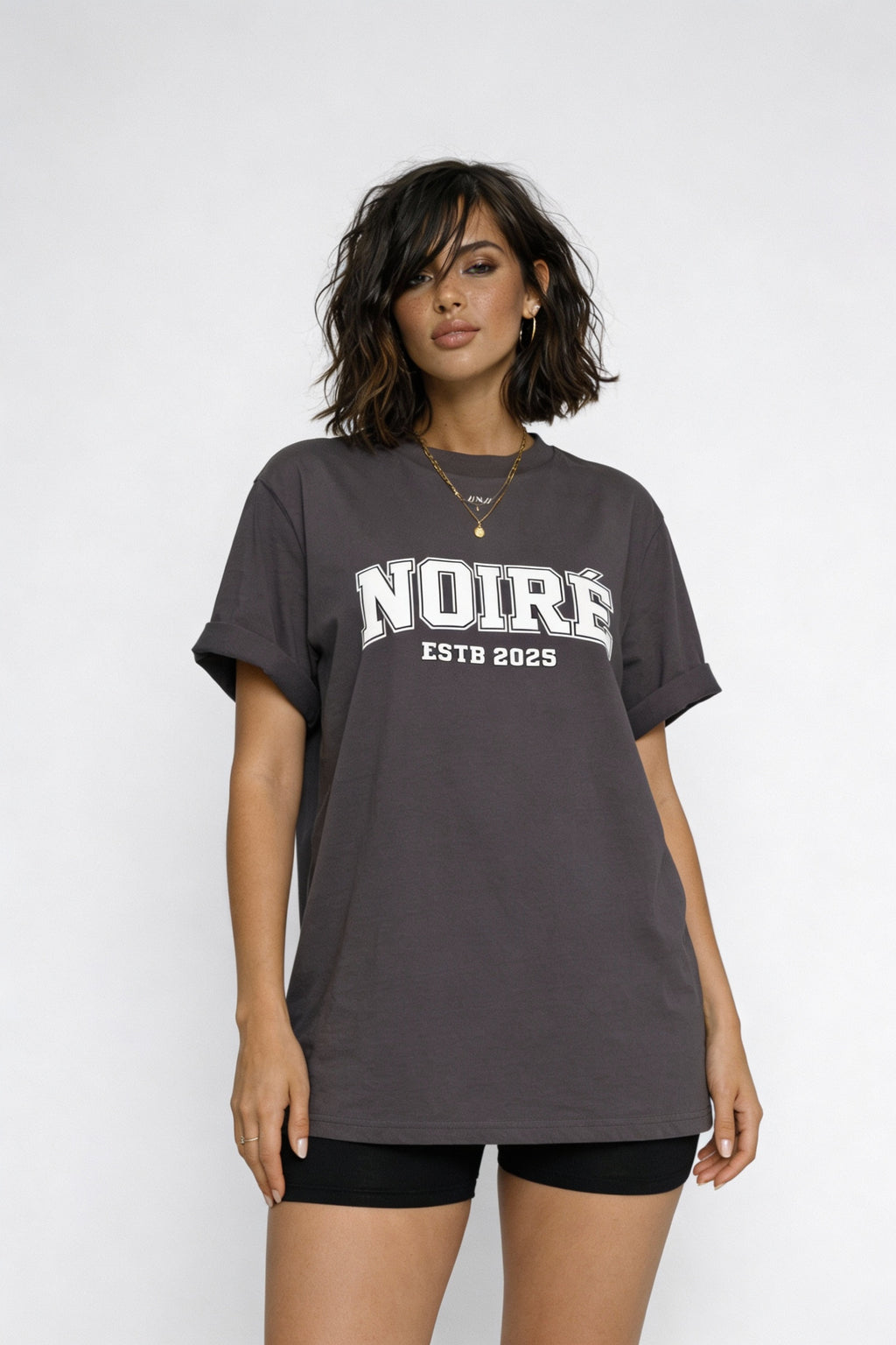 Woman wearing grey oversized Noiré logo streetwear t-shirt, relaxed everyday fit