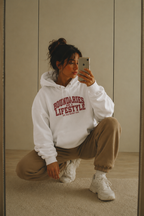 female crouching pose wearing oversized white hoodie boundaries lifestyle graphic urban streetwear outfit