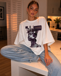 woman sitting on kitchen island wearing oversized white graphic t shirt beyond average cyber queen design urban streetwear outfit