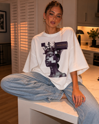 woman sitting on kitchen island wearing oversized white graphic t shirt beyond average cyber queen design urban streetwear outfit