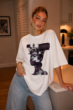woman leaning on kitchen counter wearing oversized white graphic t shirt beyond average digital queen artwork streetwear fashion