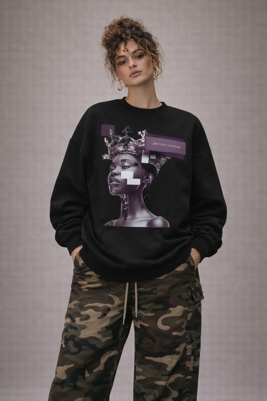 Woman in black oversized statement sweatshirt with bold purple artwork print, casual edgy streetwear style.