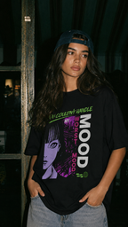 model looking away wearing oversized black graphic t shirt anime mood design urban streetwear outfit
