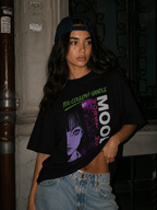 model lifting oversized black graphic tee with anime mood artwork urban streetwear outfit